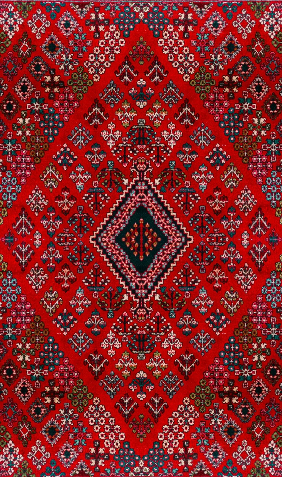 A red Persian rug with intricate geometric patterns
