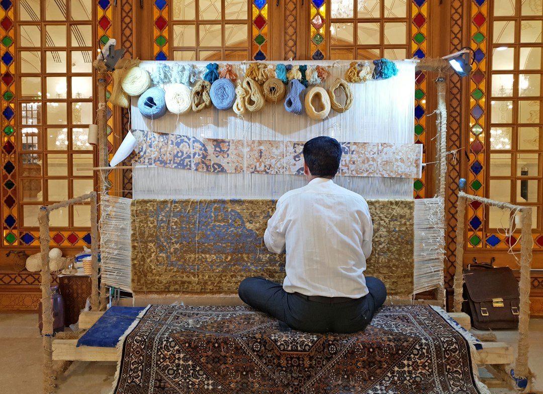 Artisan hand-knotting rug